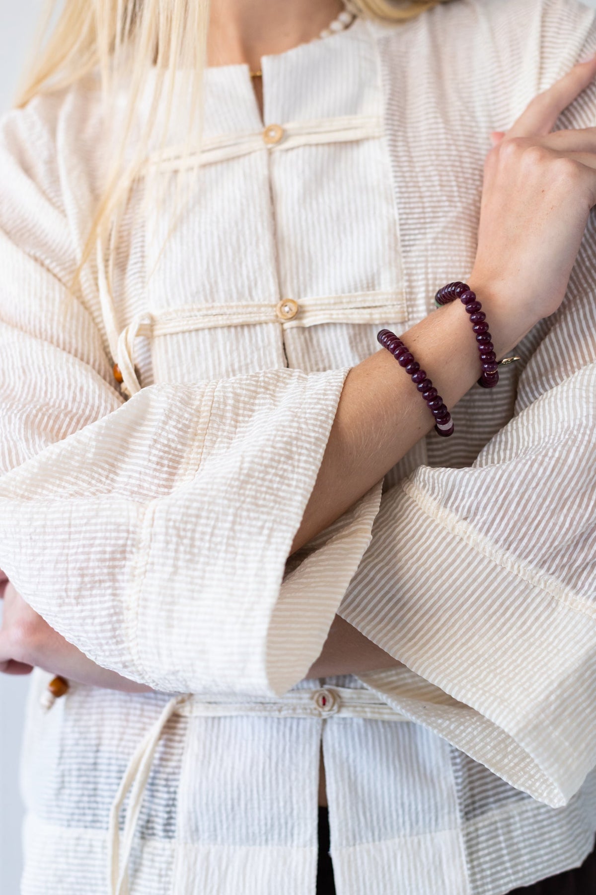 Amelia milk relaxed shirt, close up of batwing sleeve with arms crossed