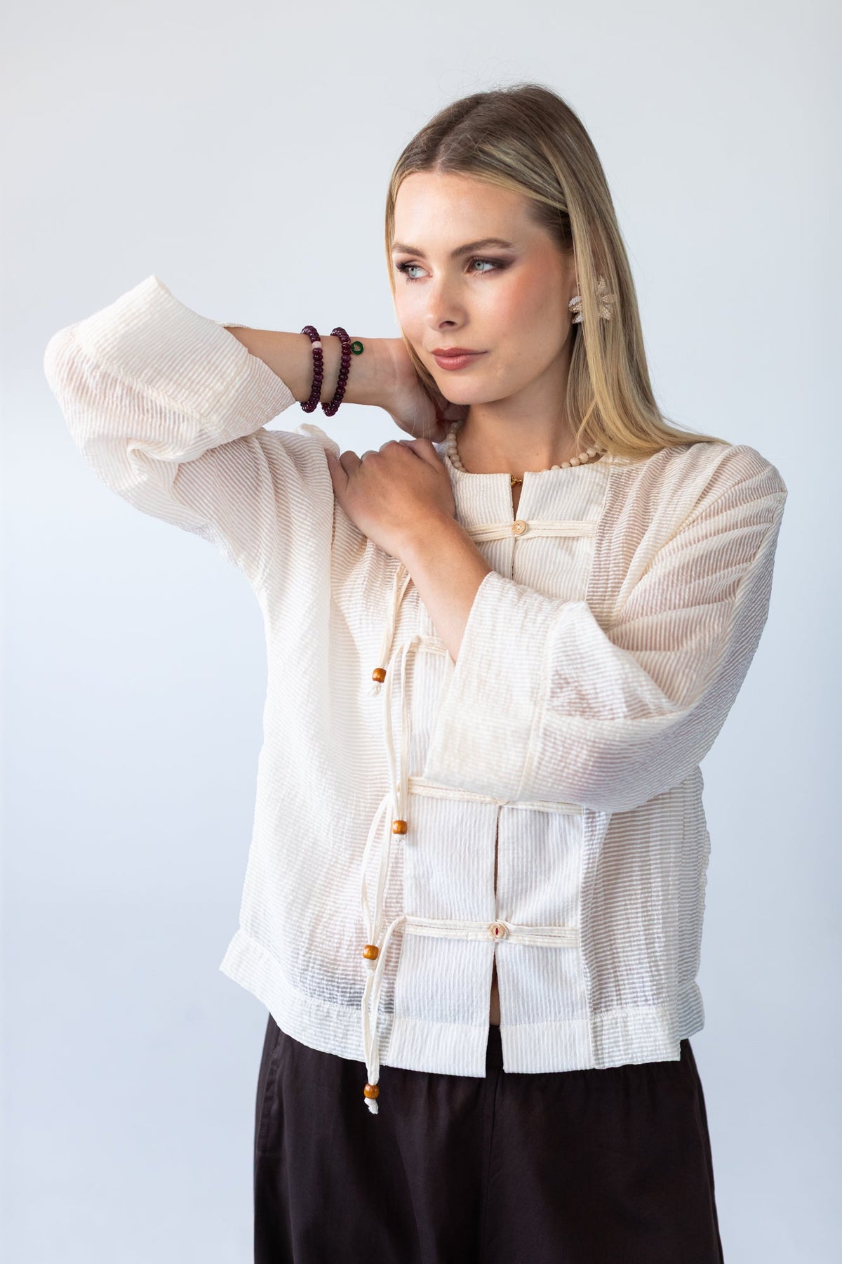 Amelia milk relaxed shirt, close up of sleeve cuff with bracelets
