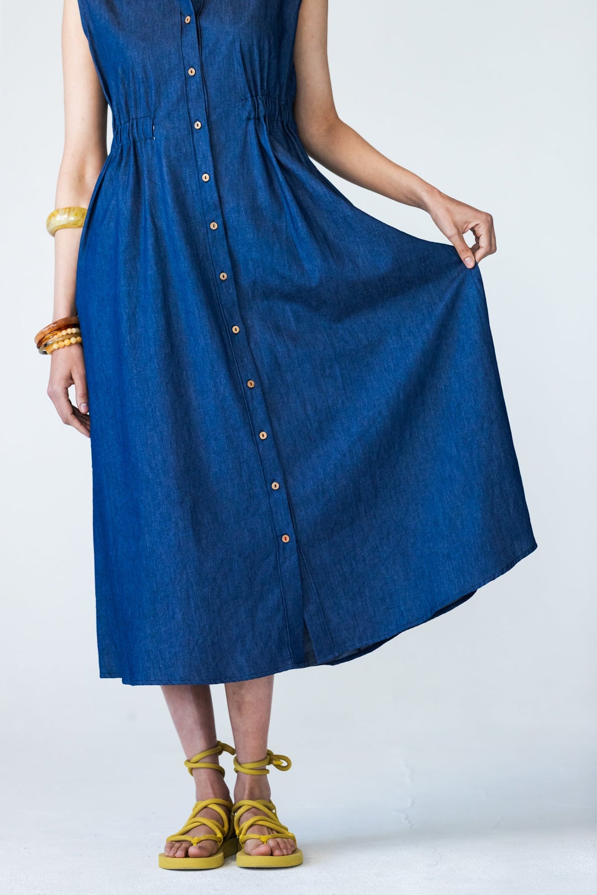 Sutton denim shirt-dress, skirt held out showing midi length, button placket and red thread on last button