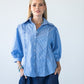 Claire blue and white stripe shirt, front view styled with denim wide-leg trousers