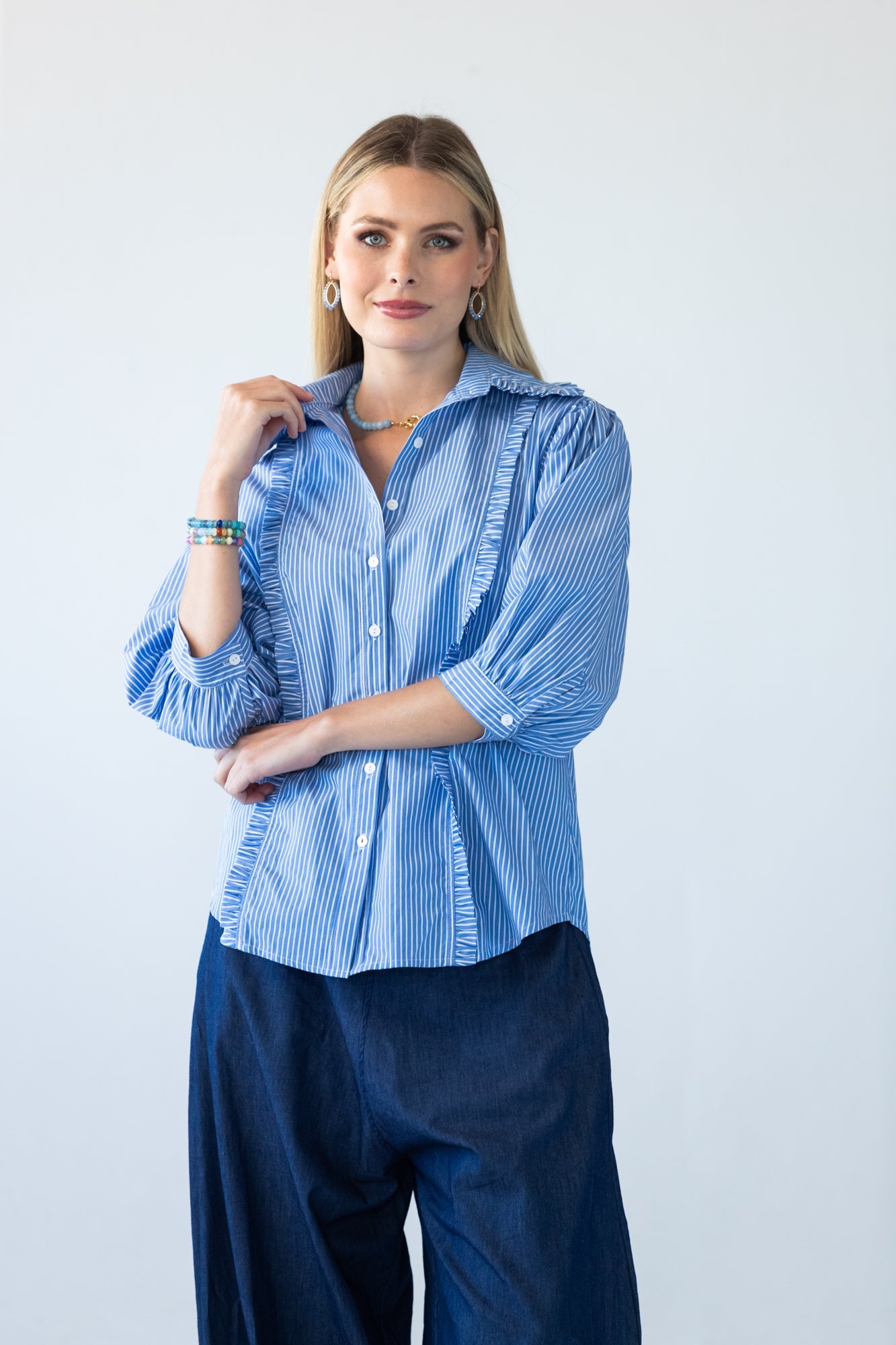 Claire frill stripe shirt, front view with arms crossed